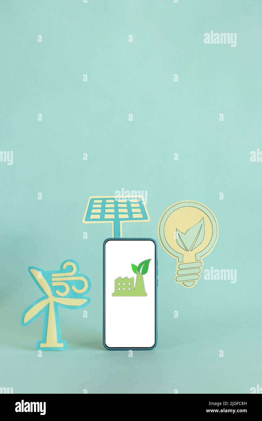 A light bulb with solar panel and wind turbine isolated on a blue ...
