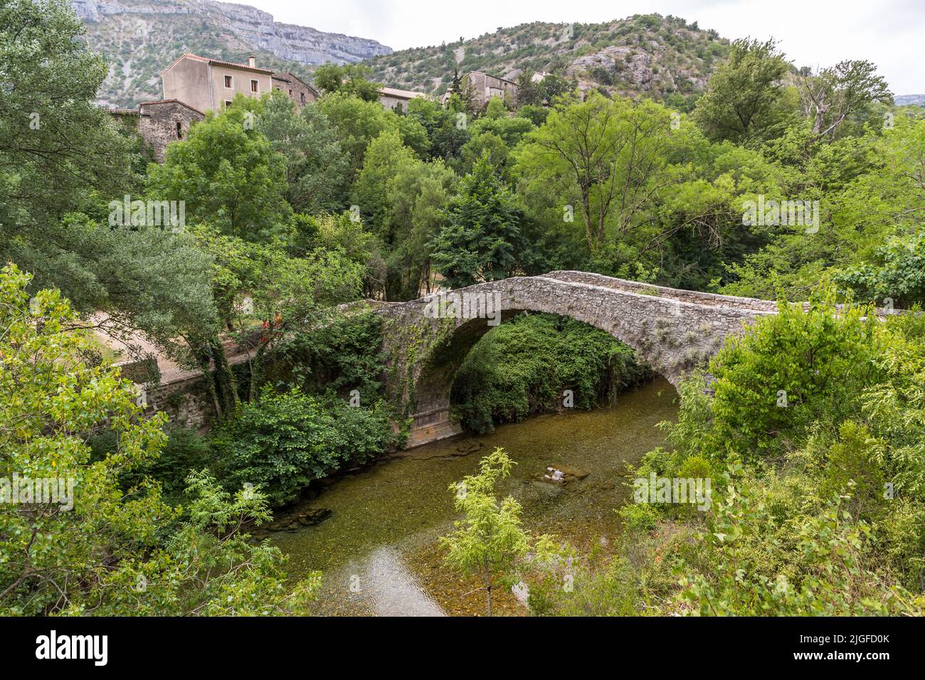 Stone arch bridge over the Vis River at Navacelles, Lodève, France. The so-called mule bridge over the foot Vis was built in 1595 so high that it remains stable even during floods Stock Photo