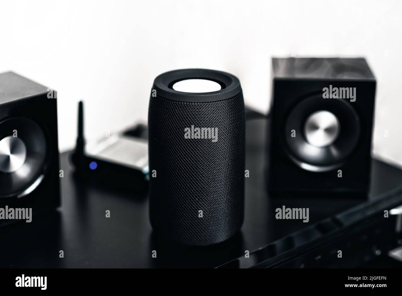 Black mini wireless portable bluetooth speaker for music listening. Stock Photo