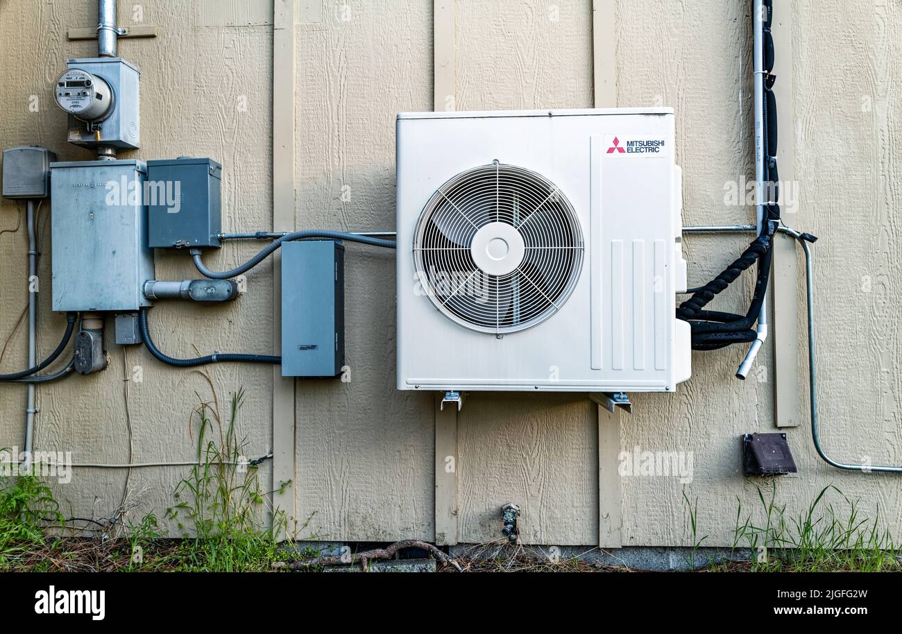 Mitsubishi air conditioner compressor fan installed on the exterior of a building in central Oregon, USA Stock Photo