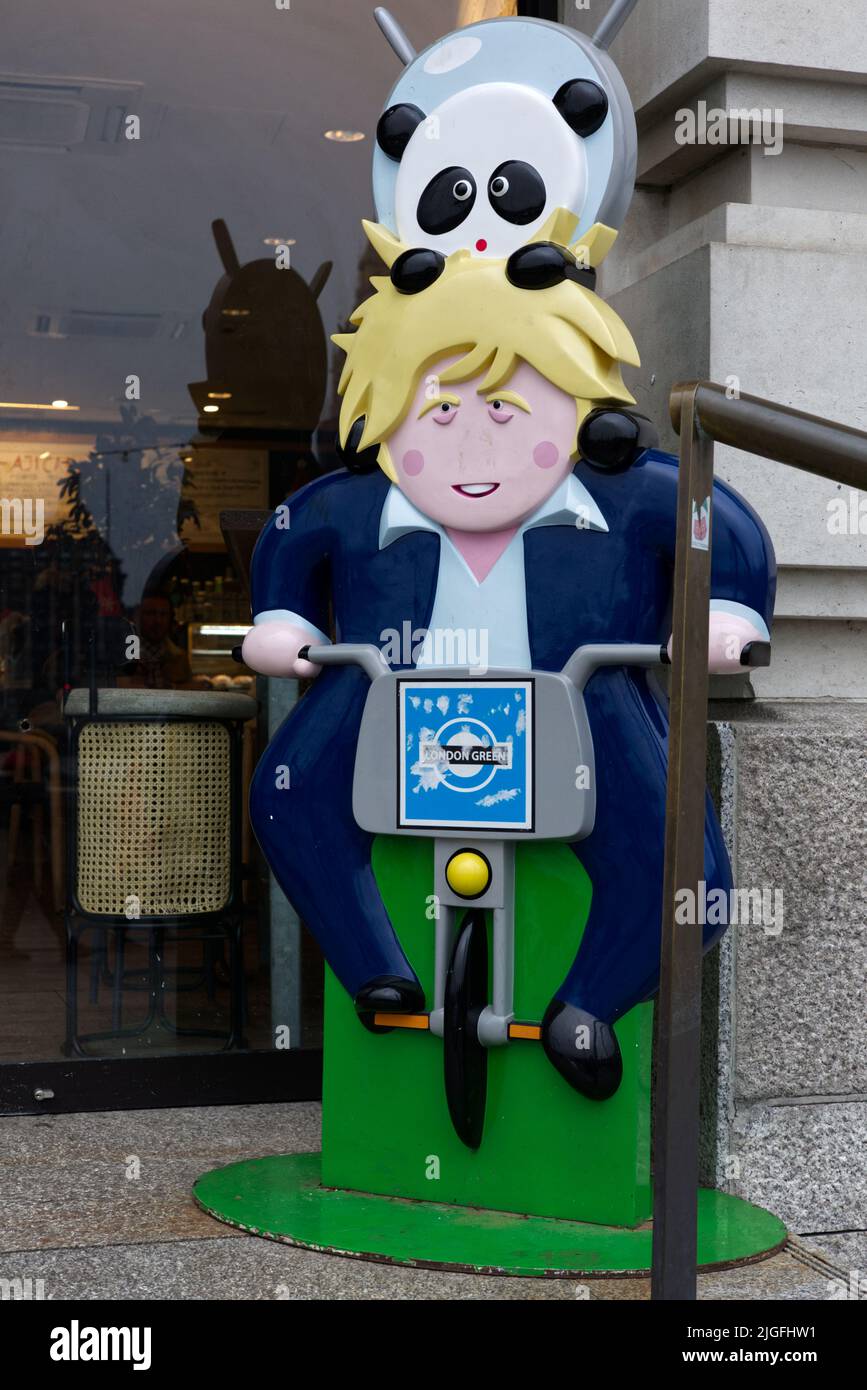 Boris Johnson cartoon, sitting on a London Green Bike Stock Photo
