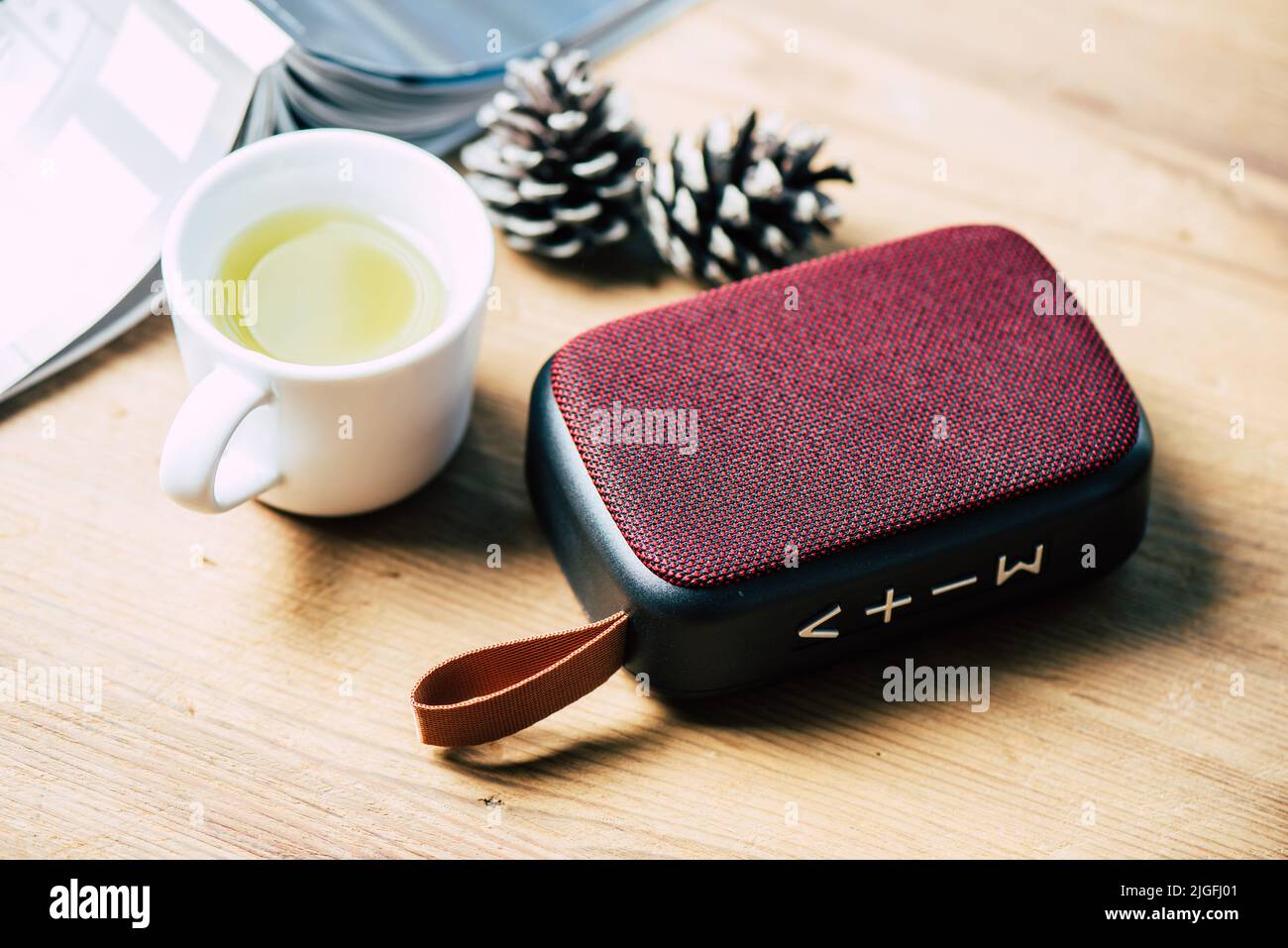relaxing concept, close up red wireless portable speaker for music listening. Stock Photo