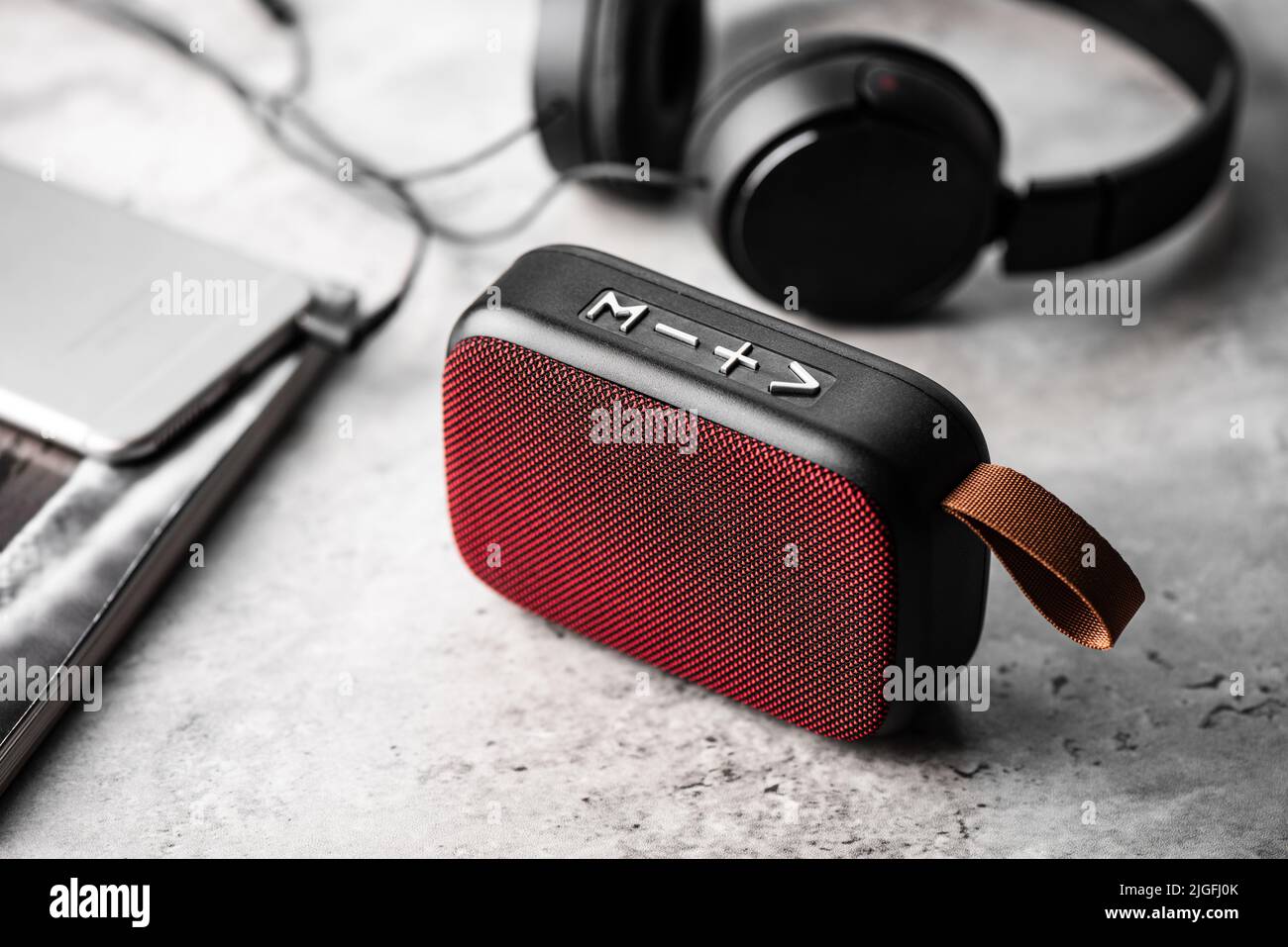 relaxing concept, close up red wireless portable speaker for music listening. Stock Photo