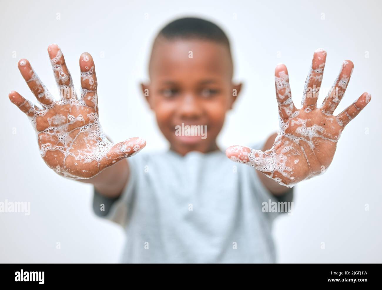 Keep your hands happy and healthy. a little boy showing his hands after washing them at home. Stock Photo
