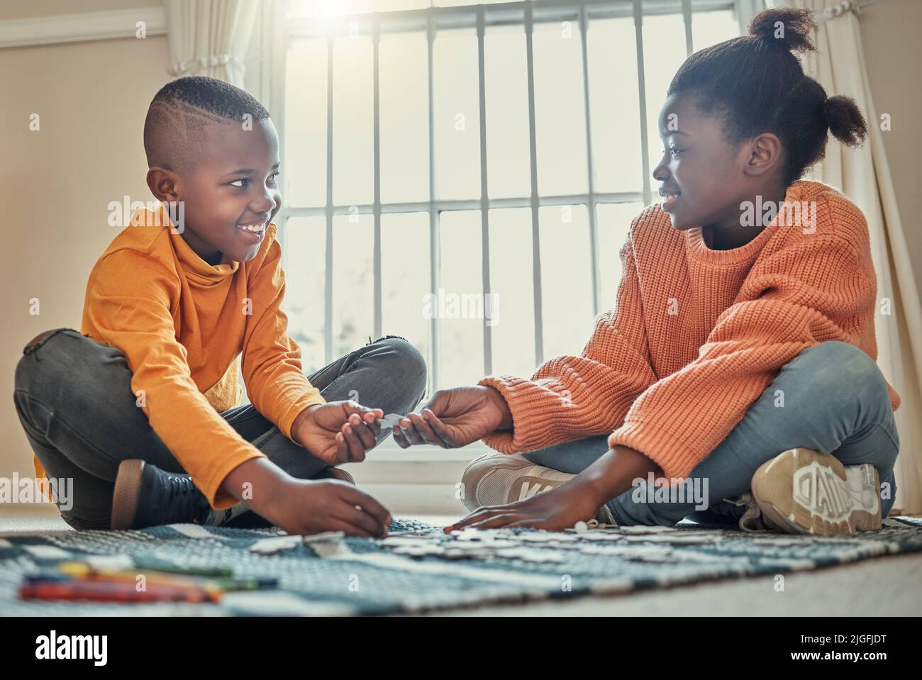 You can build this piece. a brother and sister building a puzzle