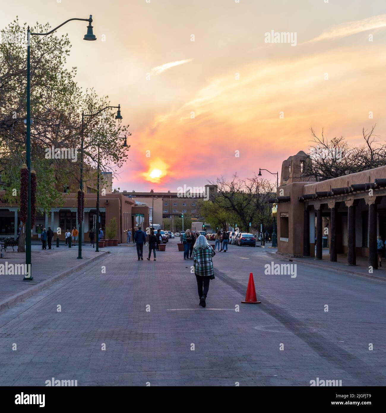 A beautiful colorful sunset with smoke from the Cerro Pelado fire in the air in Santa Fe Plaza Stock Photo