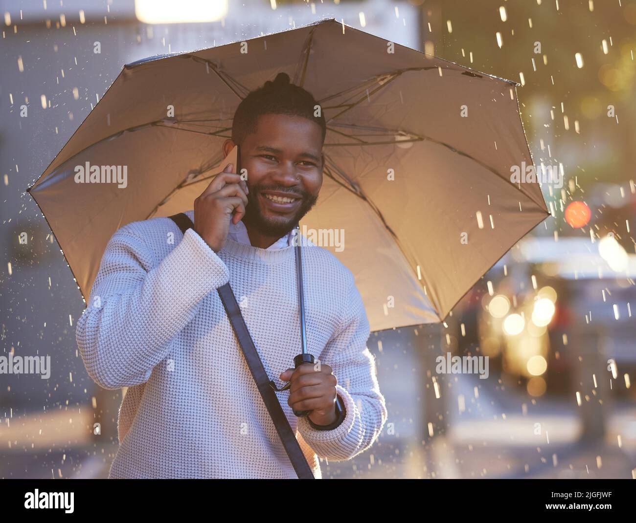 Hey where are you now a young businessman holding an umbrella while
