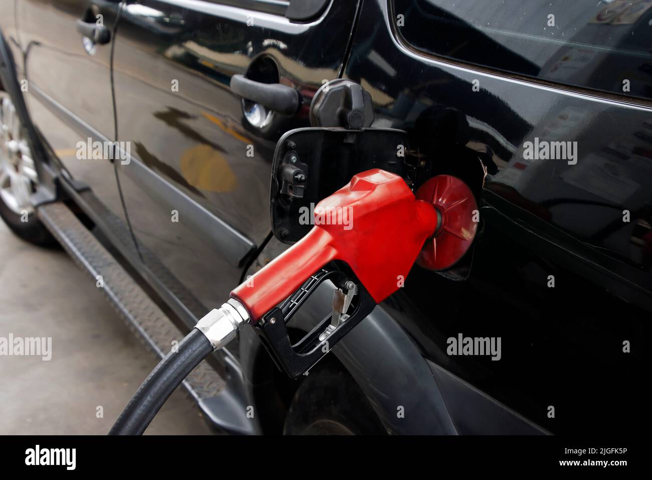 gasoline on refueling a vehicle at a gas station Stock Photo
