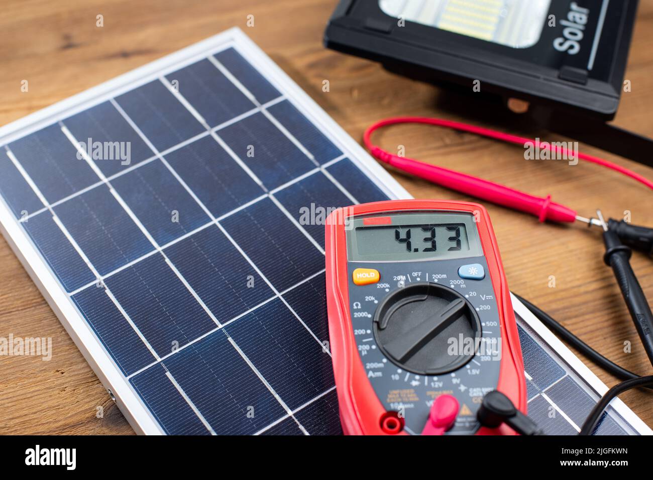 Photovoltaic or solar cell panel with multimeter. green energy concept. Stock Photo