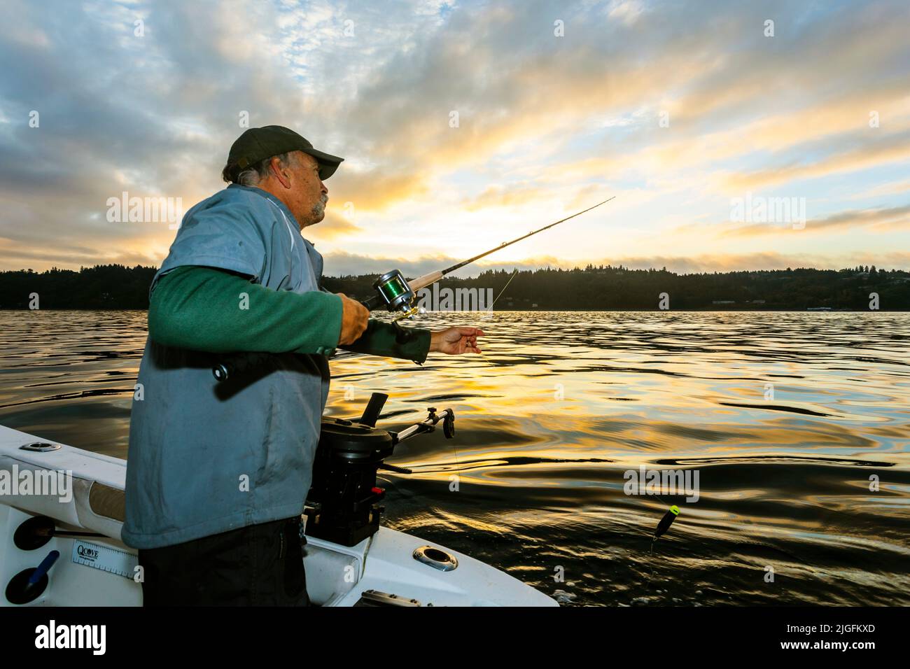 WA20626-00....WASHINGTON - Phil Russell sets a fishing pole while trolling for salmon in the Puget Sound. MR# R8 Stock Photo
