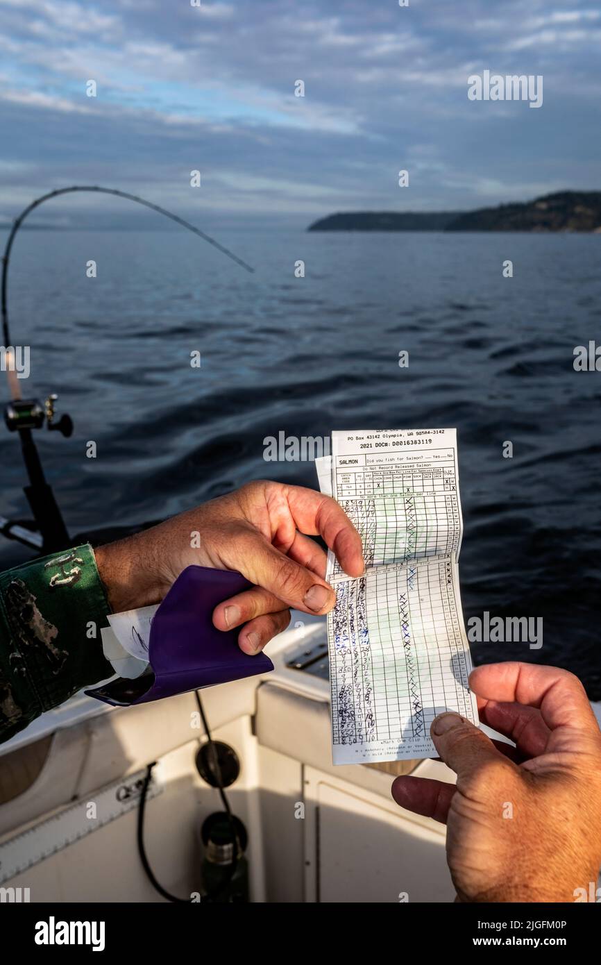 WA20632-00....WASHINGTON - Salmon catch card records the date, species and number of salmon caught. Stock Photo