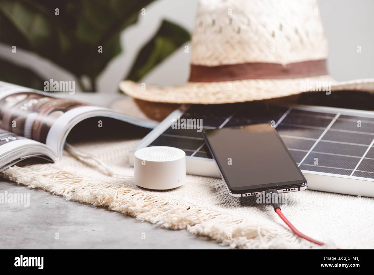 Charging the smartphone with solar energy. Green energy concept. Stock Photo