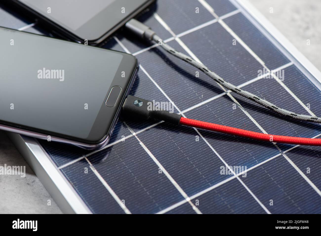Charging the smartphone with solar energy. Green energy concept Stock ...