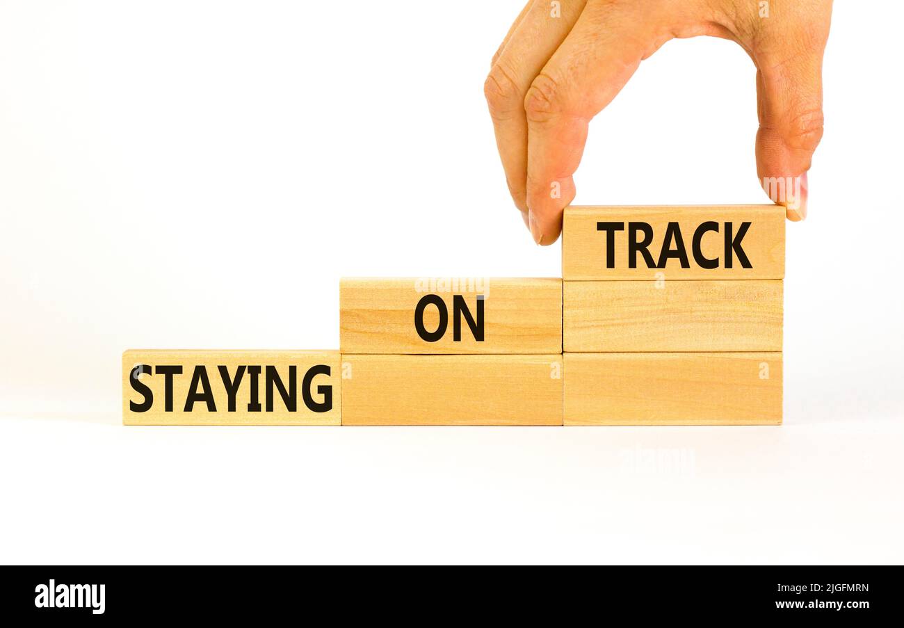 Staying on track symbol. Concept words Staying on track on wooden