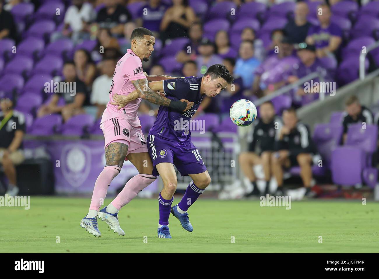 Orlando, FL:  Orlando City midfielder Mauricio Pereyra (10) heads the ball forward and away from Inter Miami midfielder Gregore (26) during an MLS gam Stock Photo