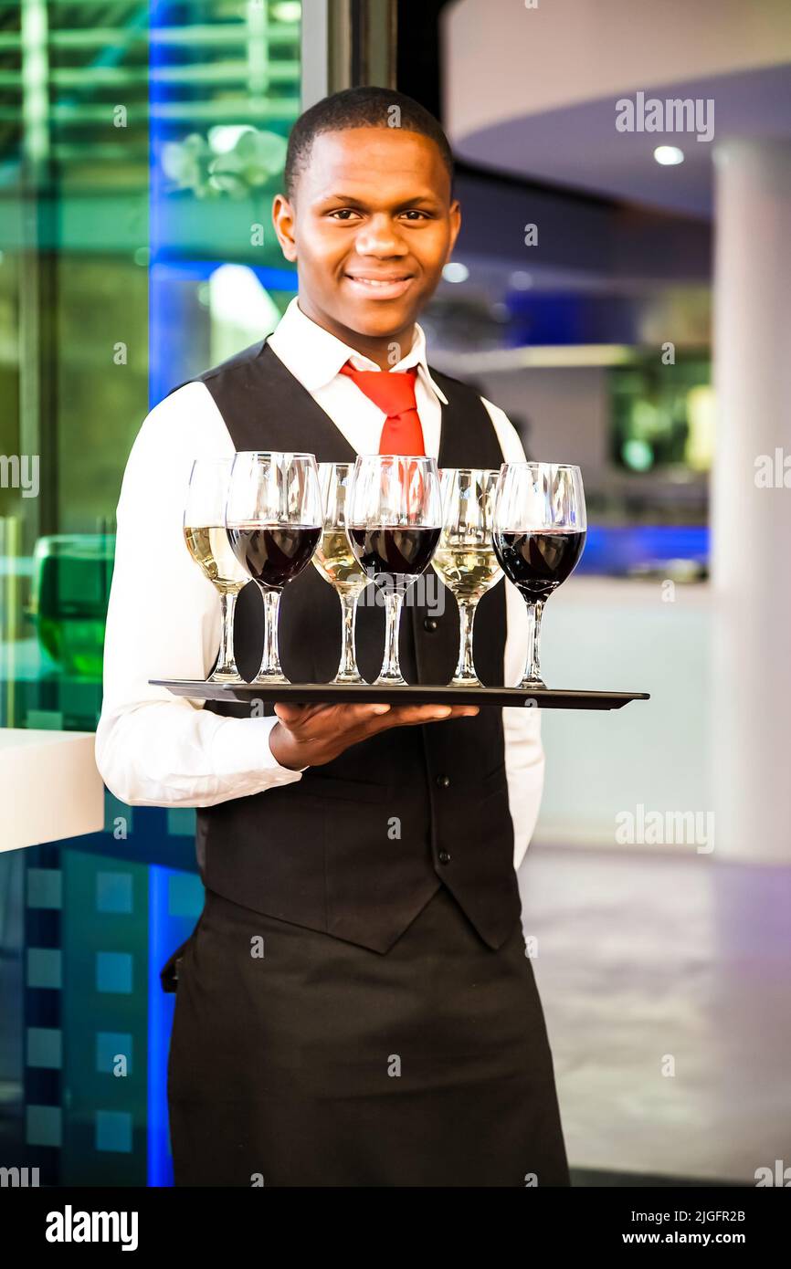 Waiter holding a tray of drinks hi-res stock photography and images - Alamy