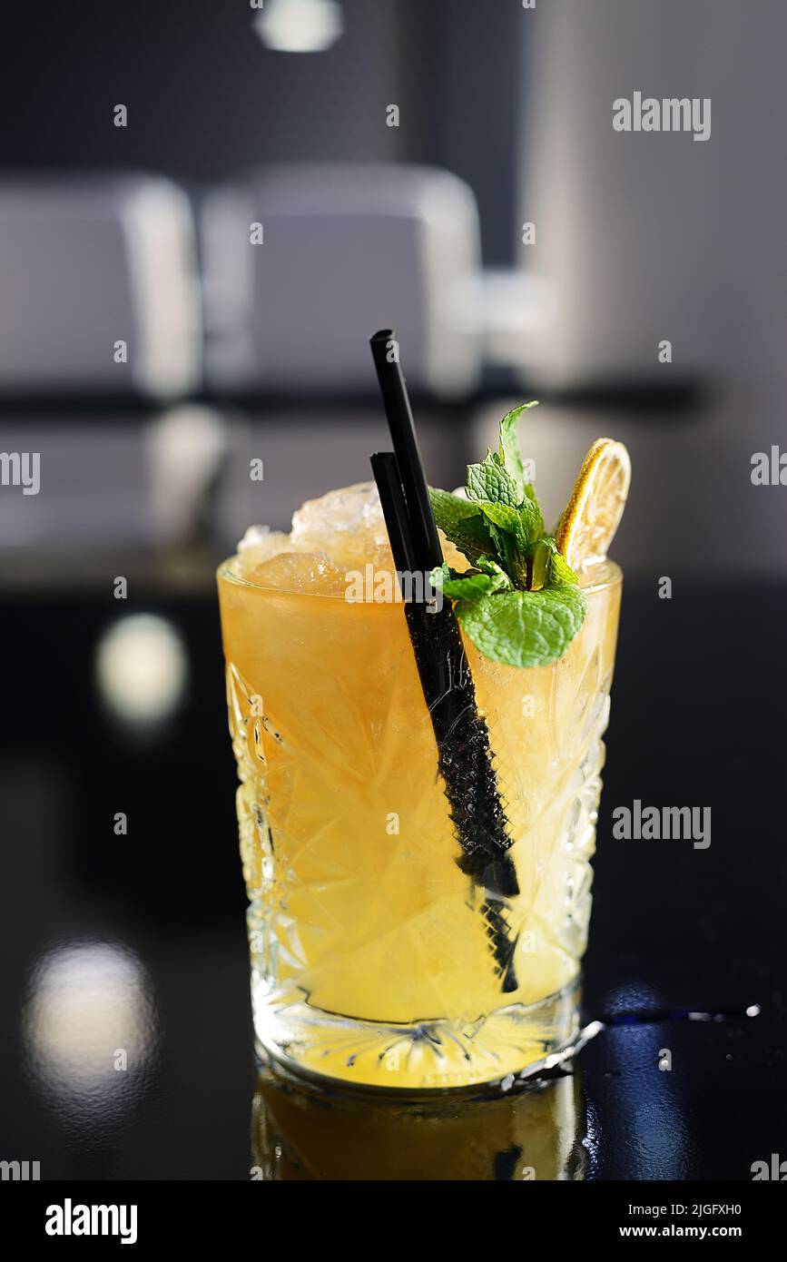Fresh cocktail with ice, mint, mango and lime on the dark background Stock Photo