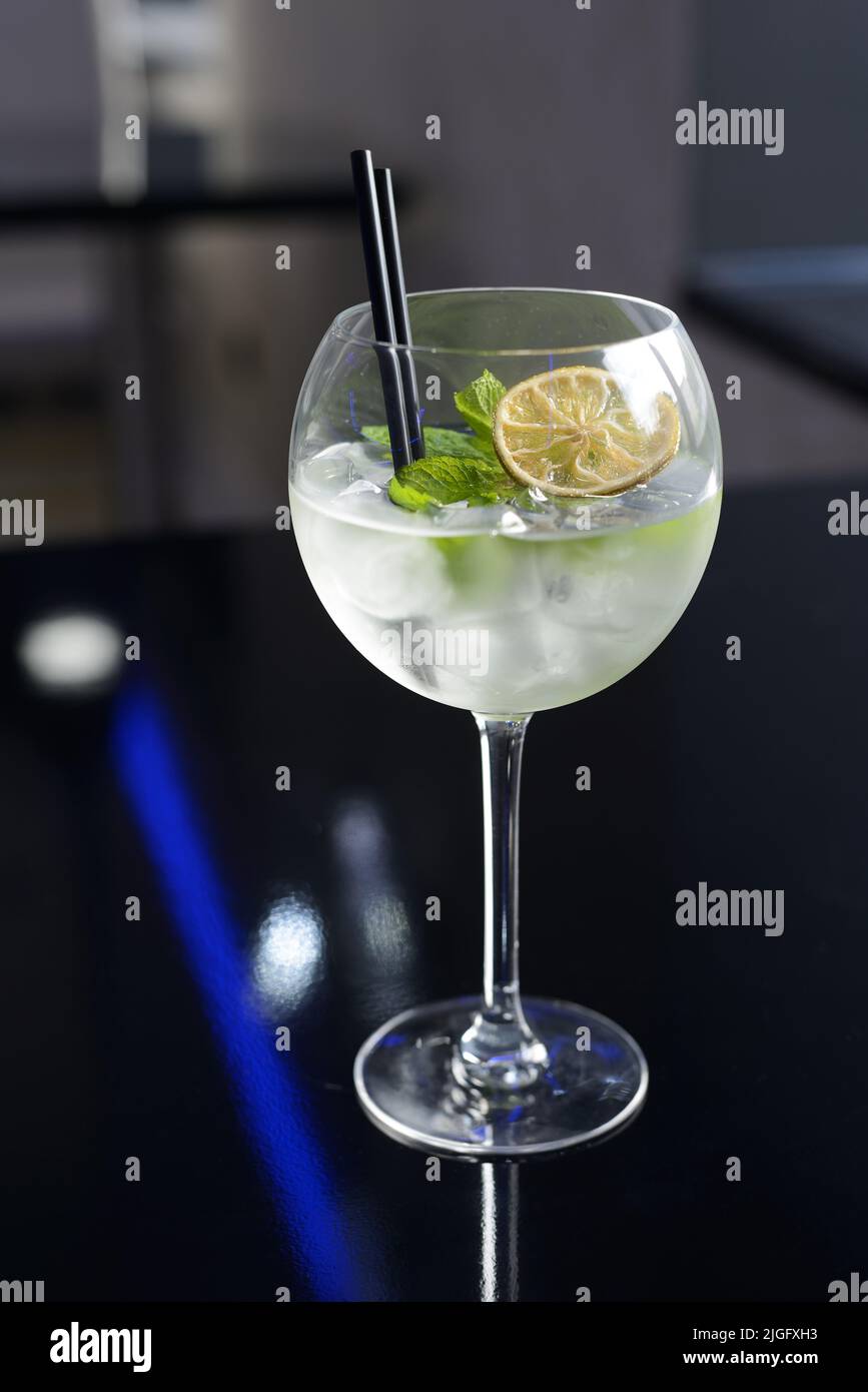Fresh cocktail with ice, mint and lime on the dark background Stock Photo