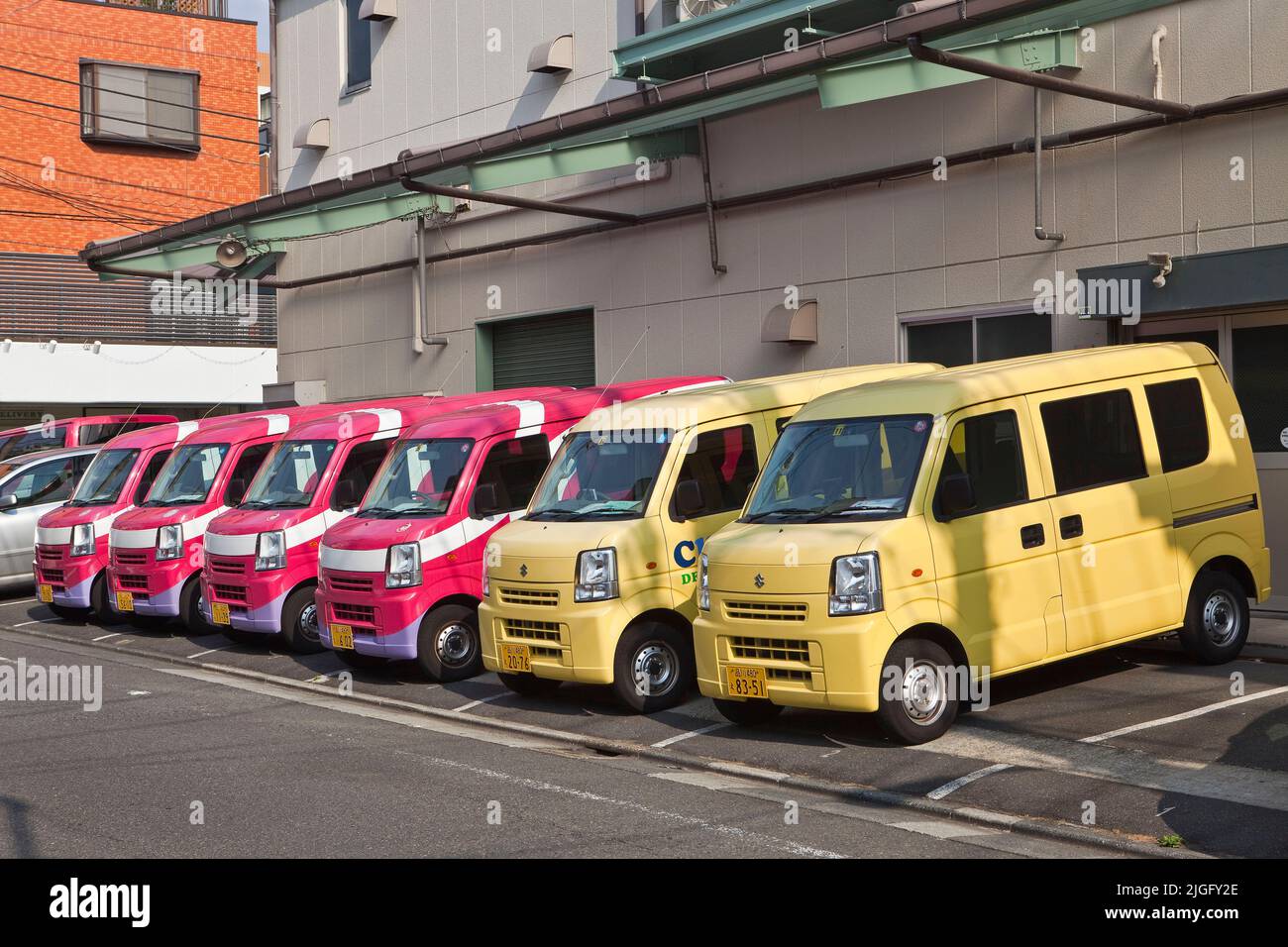 Dry cleaner delivery vehicles parked with order and precision in