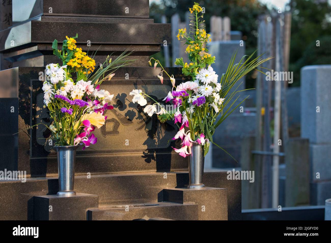 Flowers on memorial marker at Honmonji Temple cemetery in Ikegami, Tokyo, Japan Stock Photo