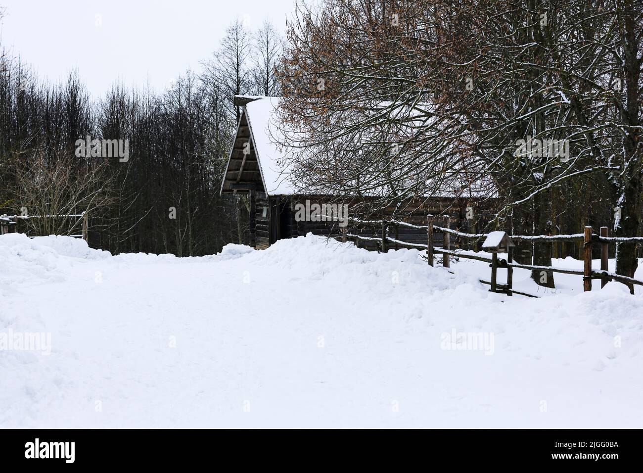 An old wooden hut. Abandoned Russian village covered in snow. Log house ...