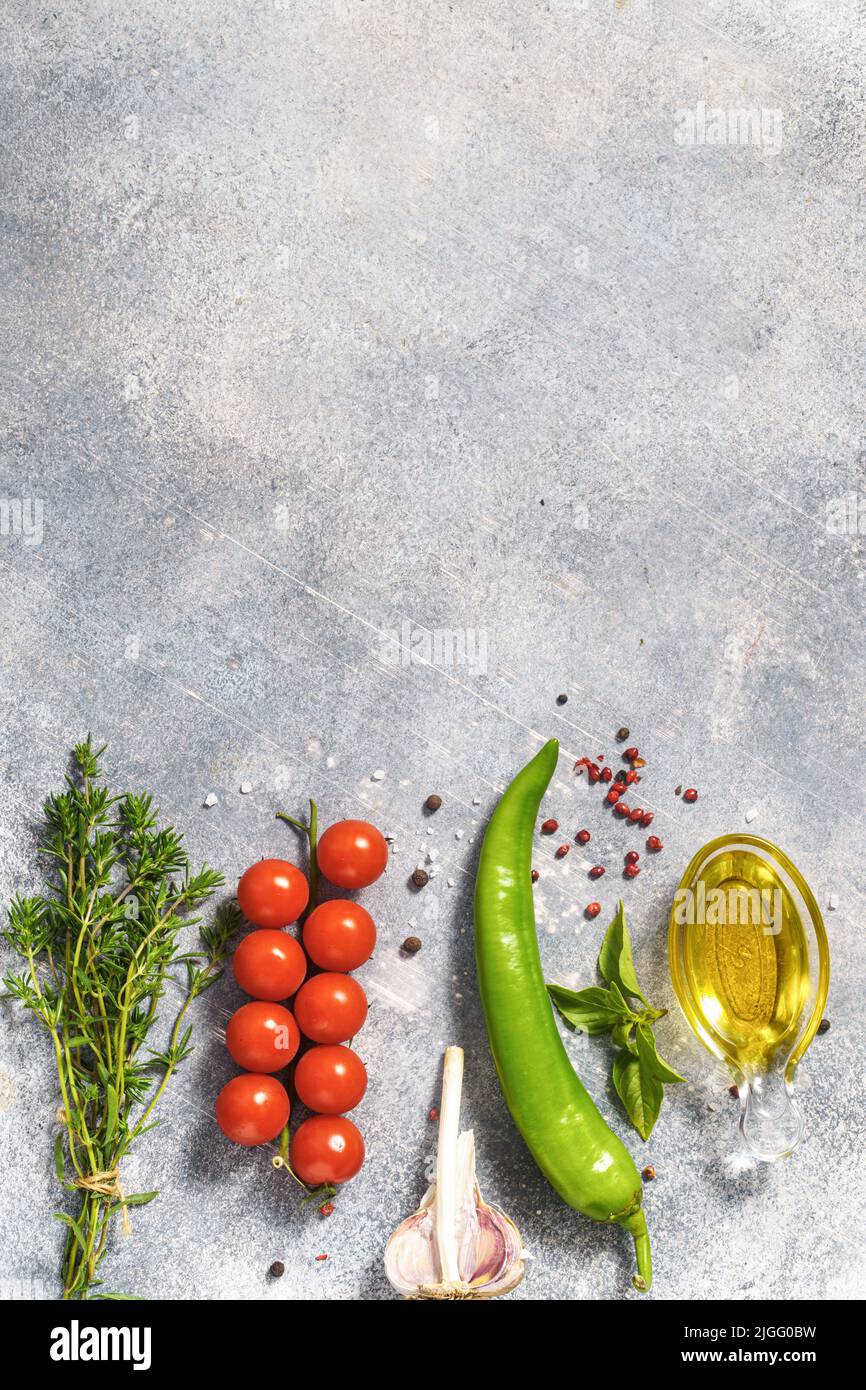 Summer savory with cherry tomatoes and other ingredients on concrete background with copy space Stock Photo