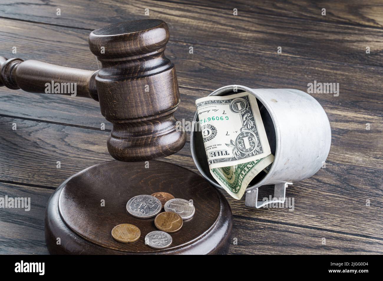 Gavel and mug with american money. Alms prohibition or charity fraud concept Stock Photo