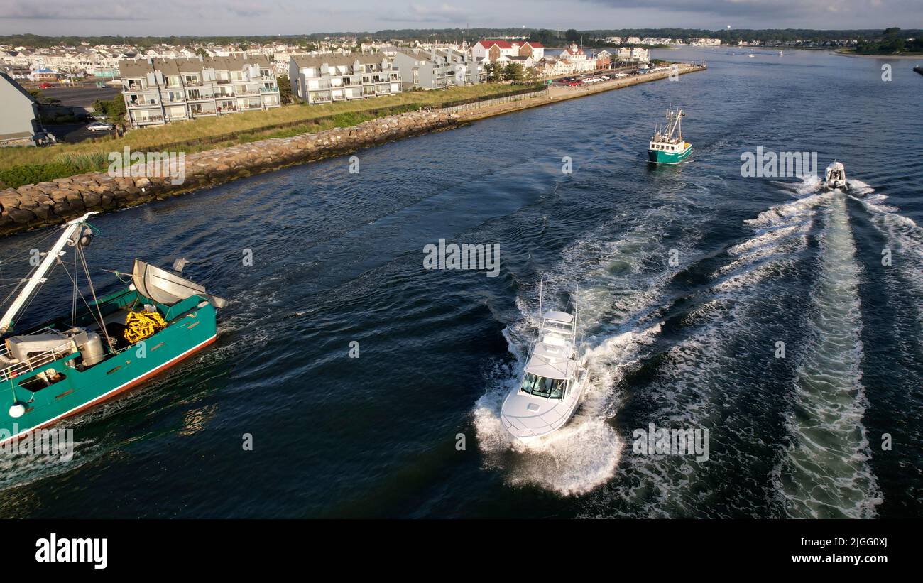Aerial view of boats along the Manasquan Inlet heading to the Atlantic Ocean In Manasquan, NJ Stock Photo