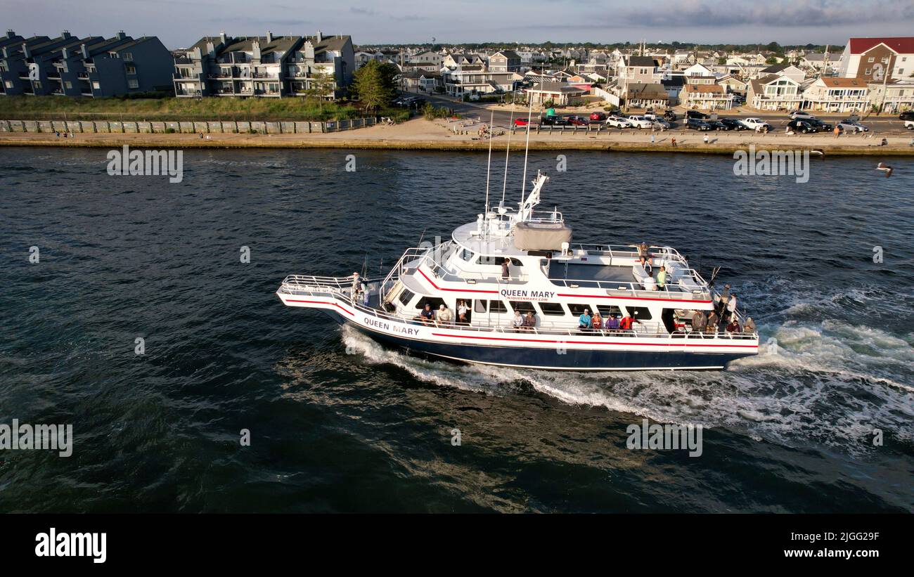 Aerial view of boat on the Manasquan Inlet heading to the Atlantic