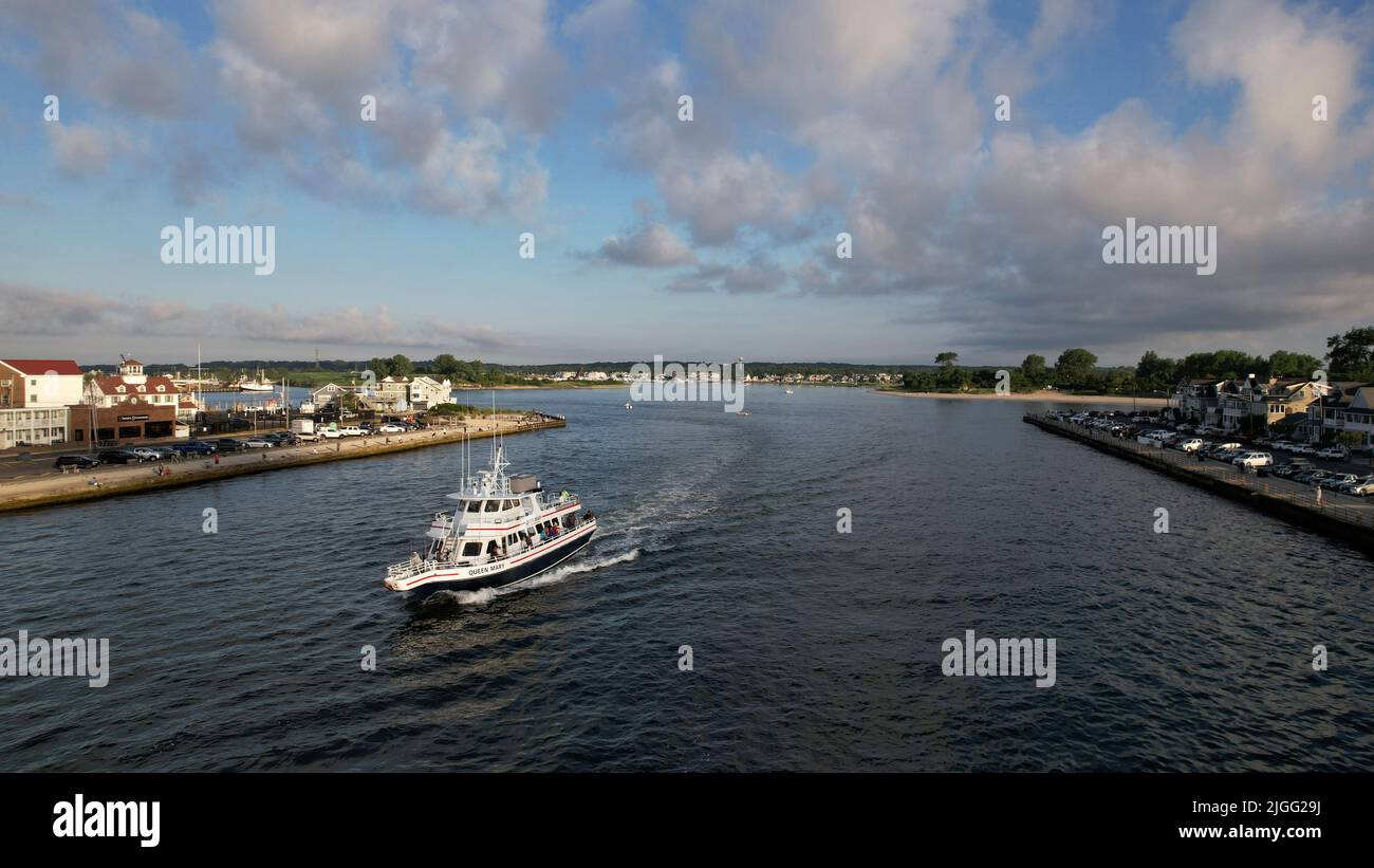 Aerial view of boat on the Manasquan Inlet heading to the Atlantic Ocean Stock Photo