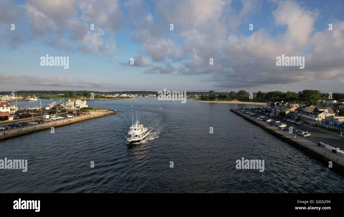 Aerial view of boat on the Manasquan Inlet heading to the Atlantic Ocean Stock Photo