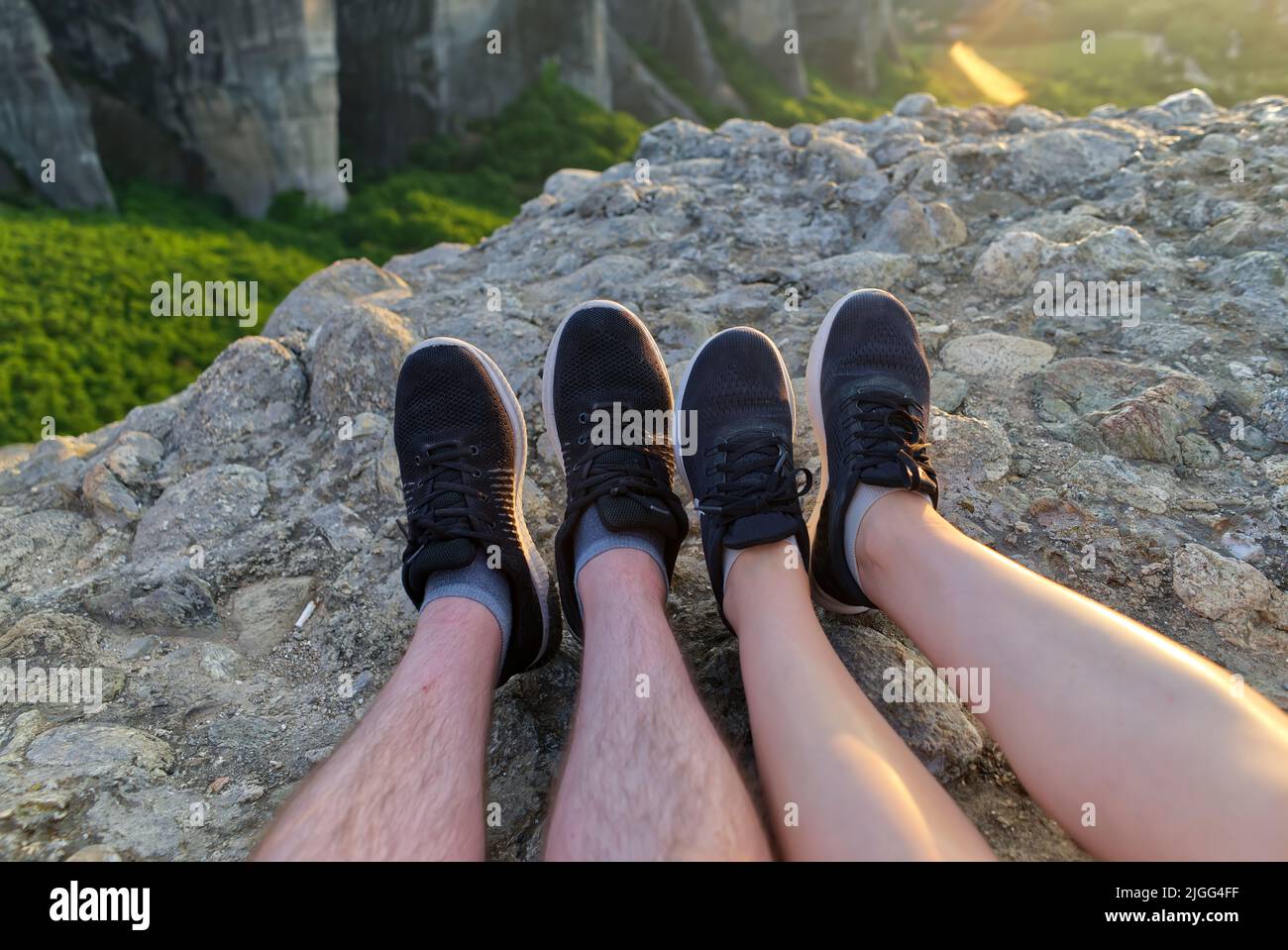 couple feet relaxing in sunny mountains, summer travel together concept. Greece, Meteora rocks Stock Photo