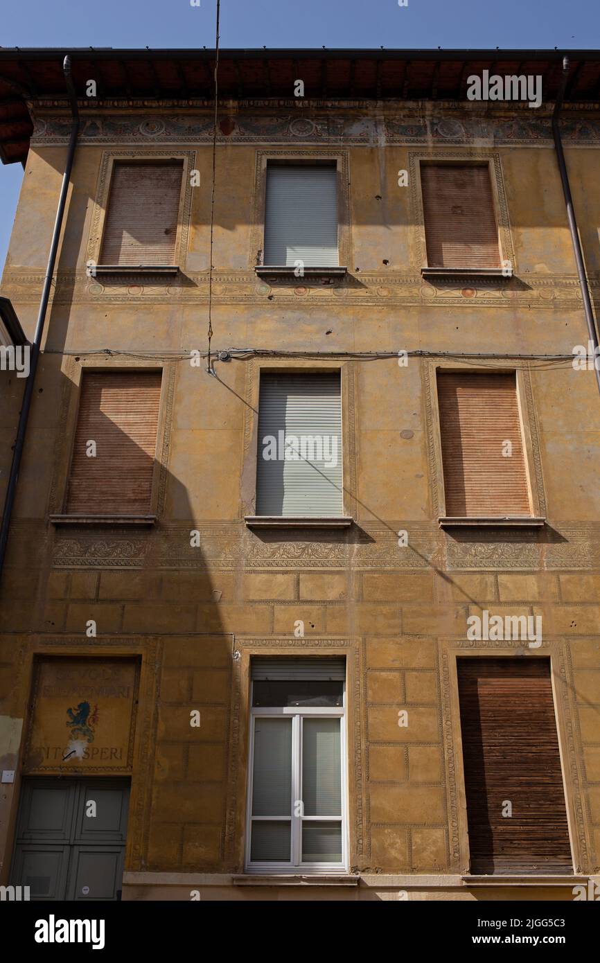Side of old building with multiple windows, Brescia, Lombardia, Italy Stock Photo