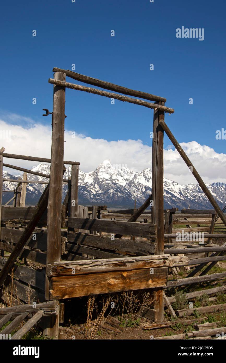 Grand Teton Peak is framed by corral fixture at a barn on the Mormon Row Historic District at the Grand Teton NP, WY. Stock Photo