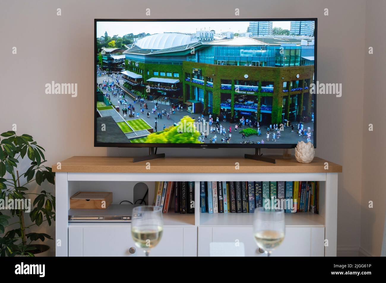 An aerial view of Centre Court and the All England Club at Wimbledon during the July 2022 Grand Slam tournament. On a flat screen tv in a lounge. UK Stock Photo