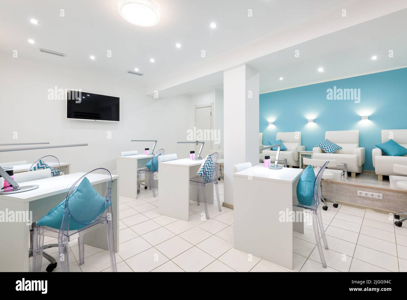 Nail salon bright interior, panorama of modern manicure shop. Inside beauty studio, spa room with white design. Clean empty trendy nail salon. Cosmeti Stock Photo