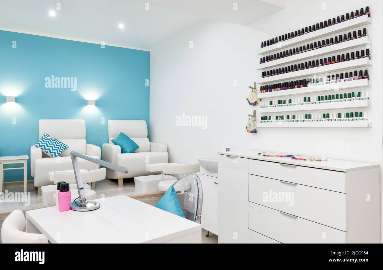 Nail salon bright interior, panorama of modern manicure shop. Inside beauty studio, spa room with white design. Clean empty trendy nail salon. Cosmeti Stock Photo