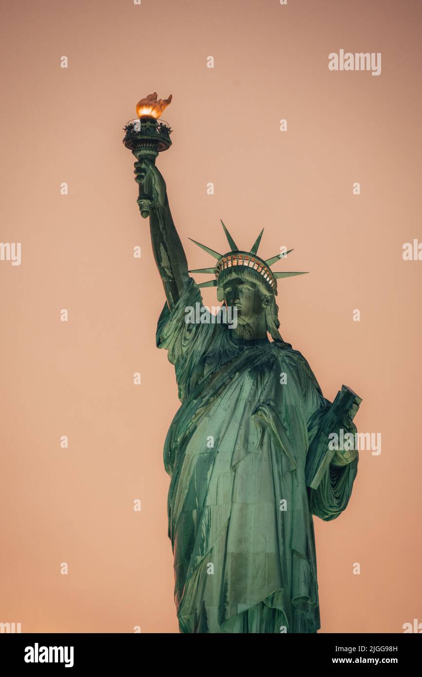 Statue of liberty, New York, USA, during the golden hour with a cloudy