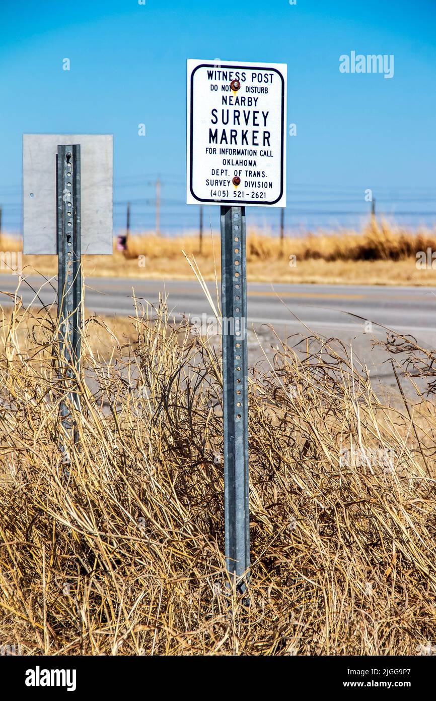 03 16 2022 Northeastern Oklahoma USA - Witness Post set as an aid in finding and positively identifying a survey point on Oklahoma prairie with blurre Stock Photo