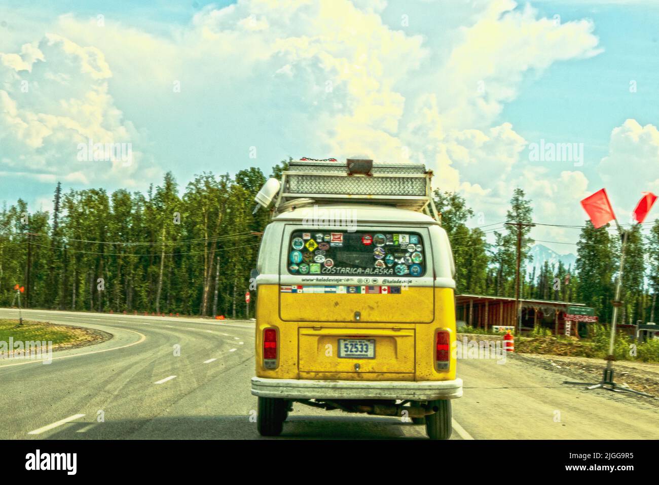 06-23-2002 Alaska USA - Yellow van that has been from Costarica to Alaska with flags and stickers of all countries its been through on back Stock Photo