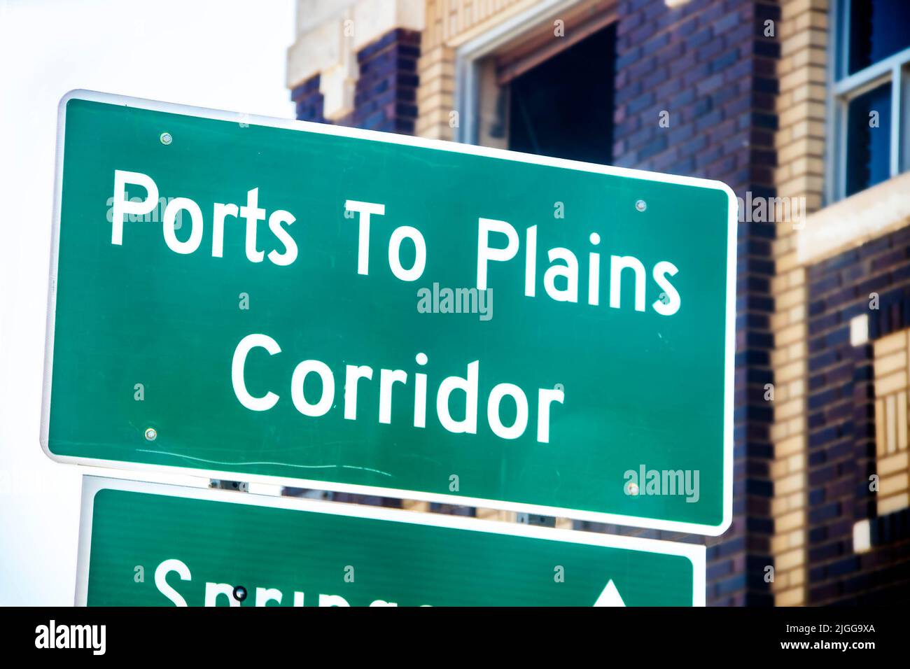 Closeup of Ports to Plains Corridor sign with blurred brick buildings in the background Stock Photo