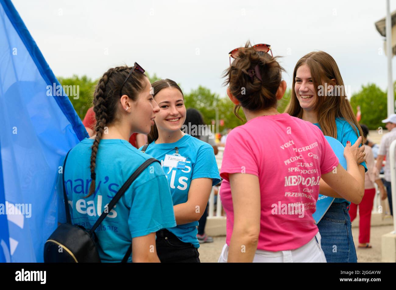 Volunteer from Mary's Meals talking to each other at Mladifest 2021, the youth festival, in Medjugorje. Stock Photo