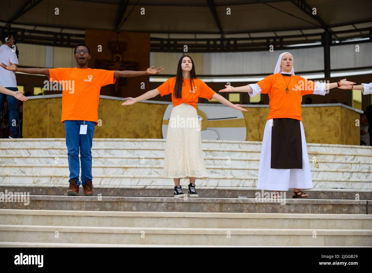 Volunteers showing hand and body motions for Christian songs at Mladifest 2021, the youth festival, in Medjugorje. Stock Photo