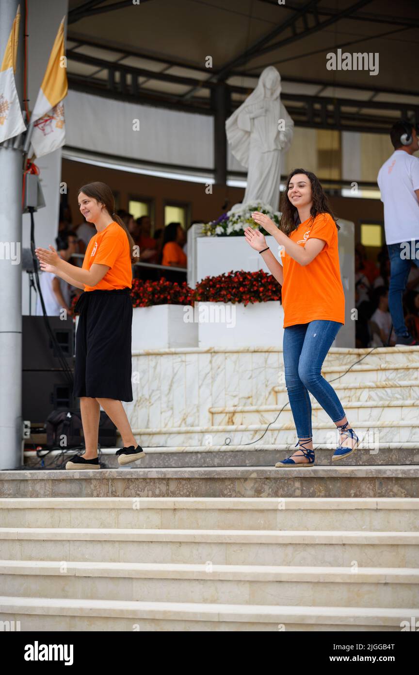 Volunteers showing hand and body motions for Christian songs at Mladifest 2021, the youth festival, in Medjugorje. Stock Photo