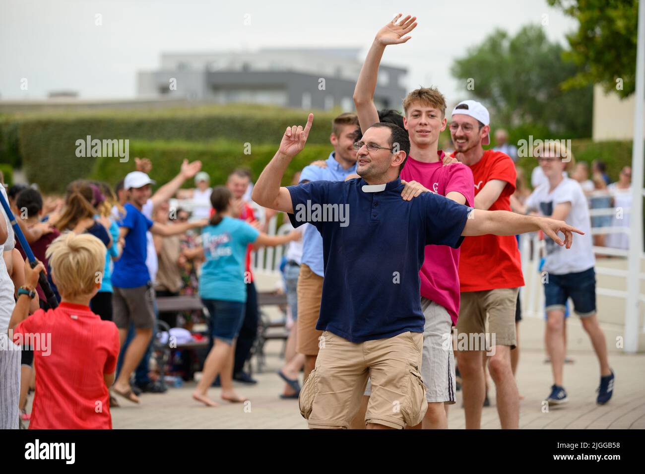 A priest leading young people in a dance to Christian songs at Mladifest 2021, the youth festival, in Medjugorje. Stock Photo