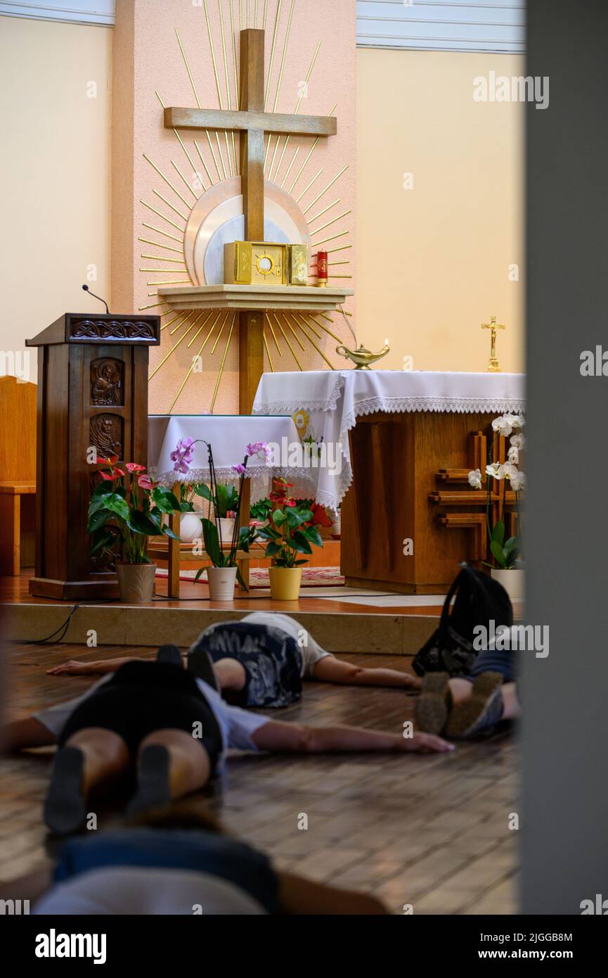 The Blessed Sacrament exposed for adoration in the adoration chapel in Medjugorje. People are praying in prostration. Stock Photo