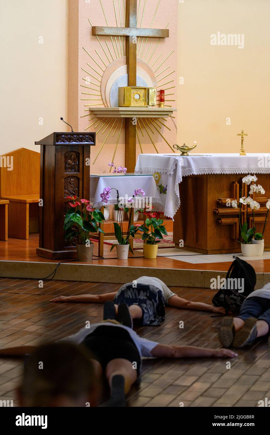 The Blessed Sacrament exposed for adoration in the adoration chapel in Medjugorje. People are praying in prostration. Stock Photo