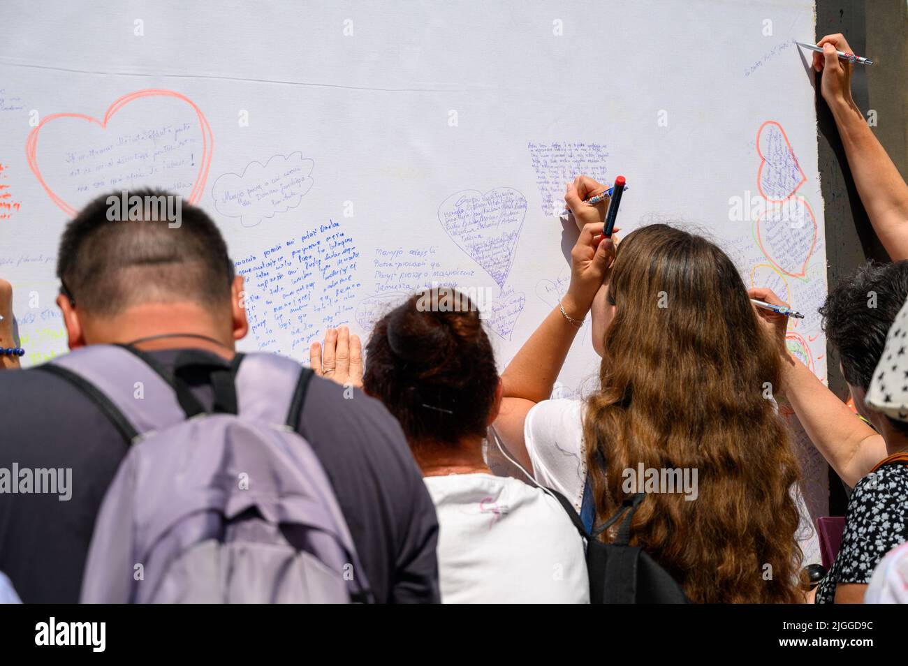 Young people writing their prayers onto a long roll of sheet during Mladifest 2021 – the youth festival – in Medjugorje. Stock Photo
