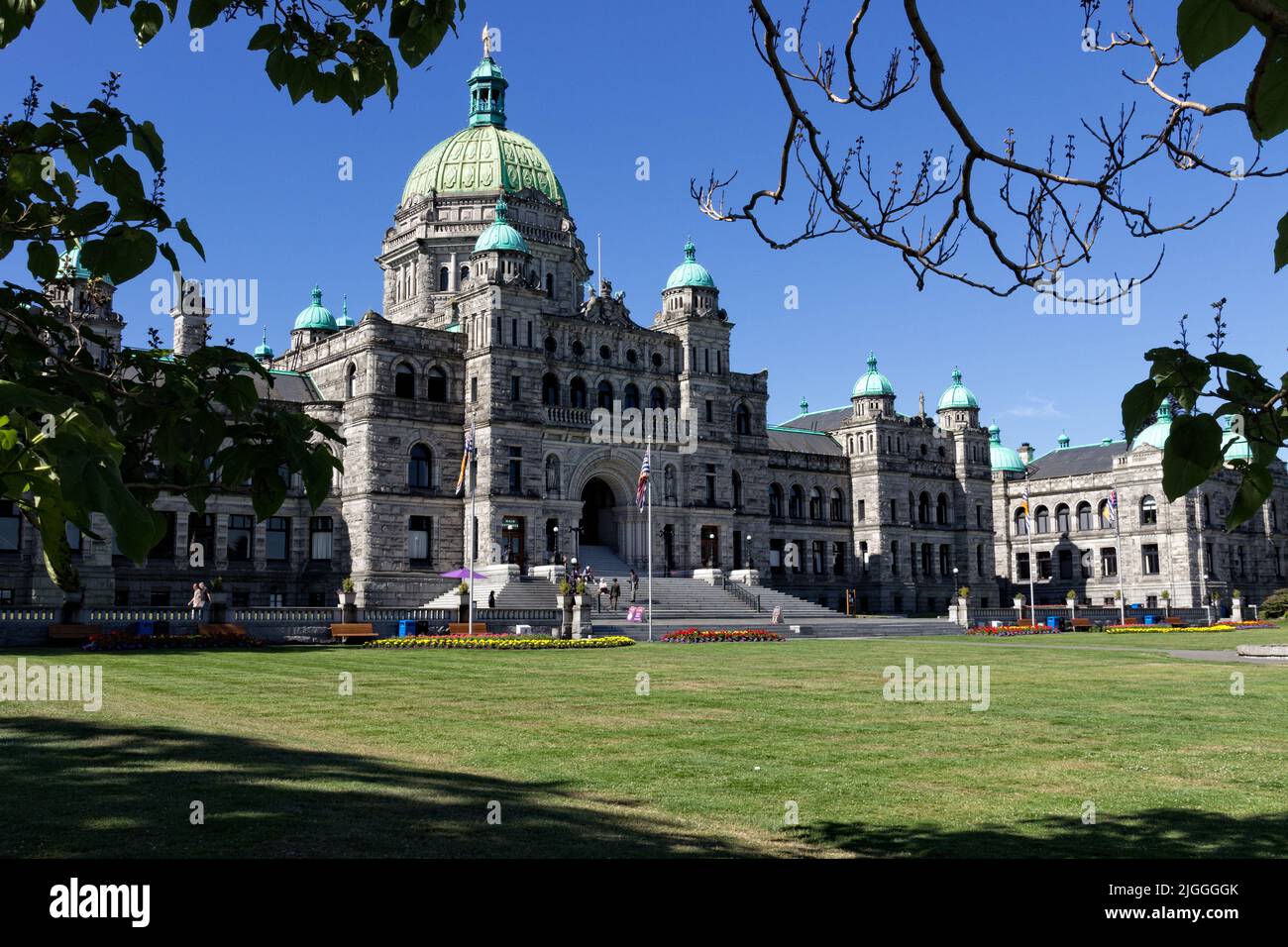 The Legislative Assembly Building in Victoria, British Columbia is photographed from a well shaded area that helps frame the scene and capture detail. Stock Photo