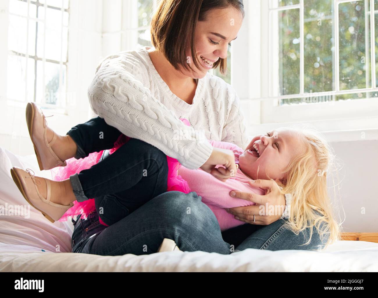 Seeing her smile makes me so happy. a young mother and daughter spending time together at home. Stock Photo